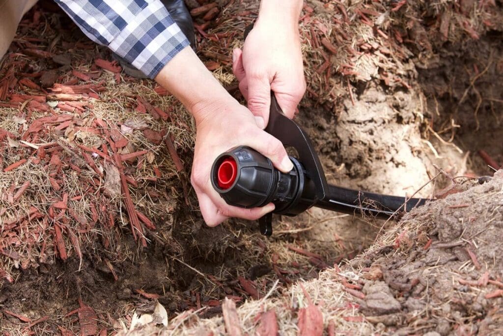 Philmac agricultural fitting used in a farm irrigation line for reliable water delivery.